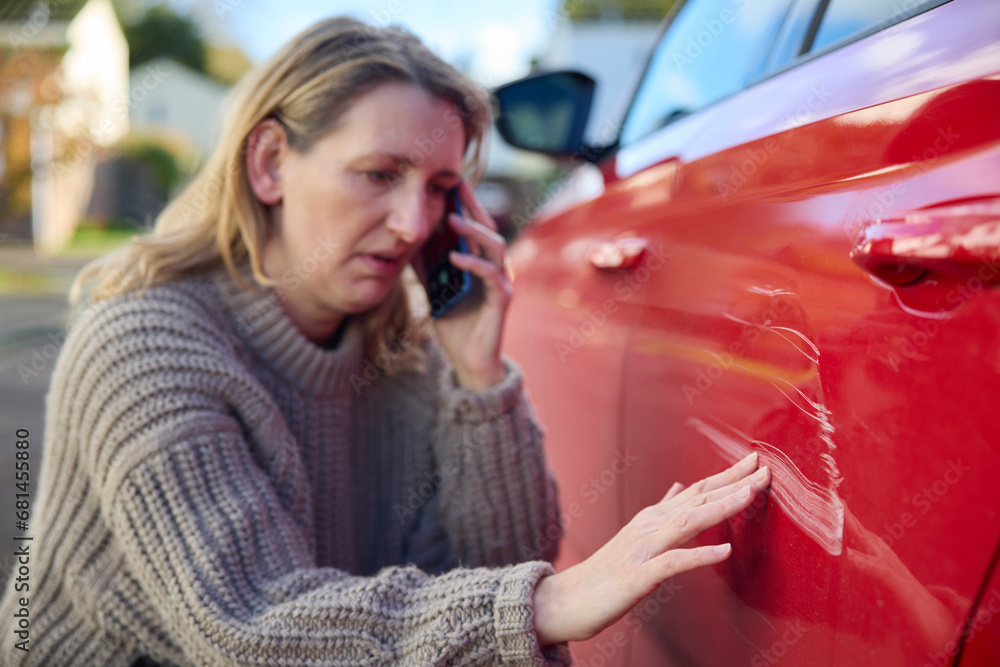Unhappy Mature Female Driver With Damaged Car After Accident Calling Insurance Company On Mobile Phone - obrazy, fototapety, plakaty 