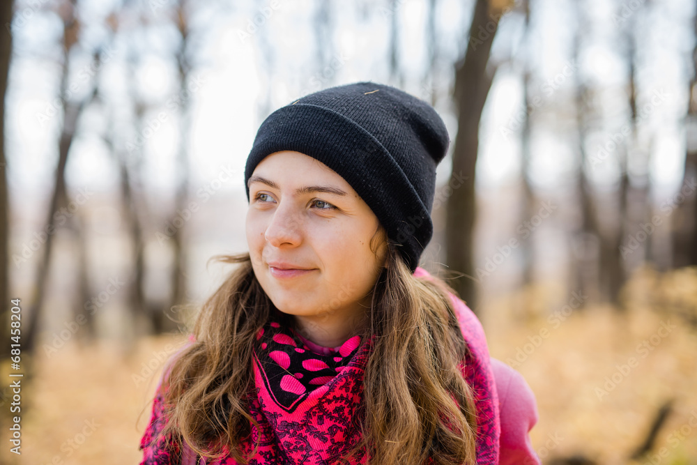 Beautiful happy smiling girl with long hair wearing black hat and pink jacket posing in autumn park. Outdoor portrait day light. Autumn mood concept. Generation Z and gen z youth. Copy empty space for Beautiful happy smiling girl with long hair wearing black hat and pink jacket posing in autumn park. Outdoor portrait day light. Autumn mood concept. Generation Z and gen z youth. Copy empty space for