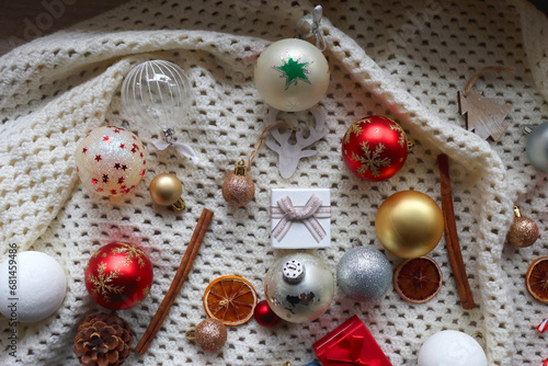 Various colorful Christmas ornaments, small presents and seasonal spices on white knitted blanket. Top view. © jelena990