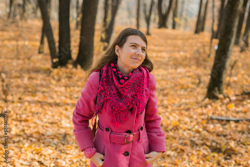 Beautiful happy smiling girl with long hair wearing black hat and pink jacket posing in autumn park. Outdoor portrait day light. Autumn mood concept. Generation Z and gen z youth. Copy empty space for