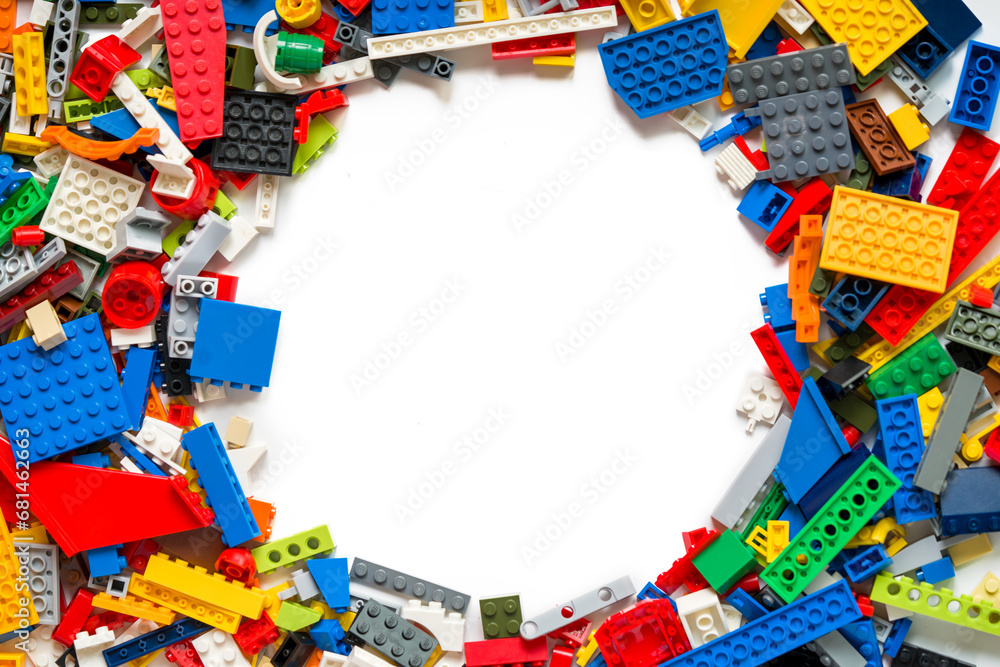 Naklejka premium Toy Brick Stack Creating Border on White Surface. Copy space for text. Lego blocks. Novosibirsk, Russia - October 26, 2023.