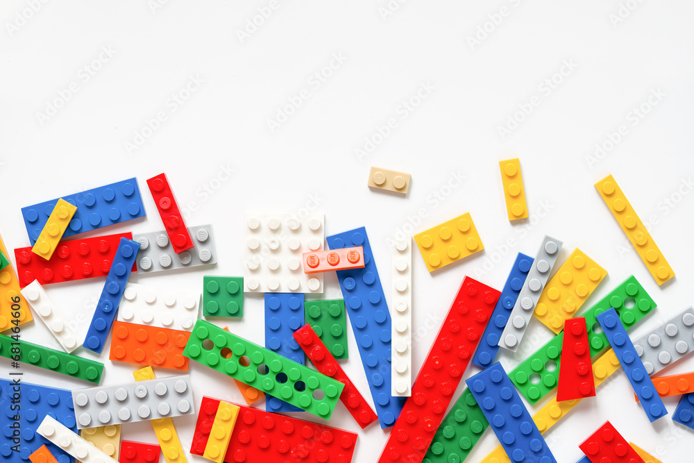 Fototapeta premium Border of Various Toy Blocks on White: Creative Construction Play. Lego blocks. Novosibirsk, Russia - October 26, 2023.