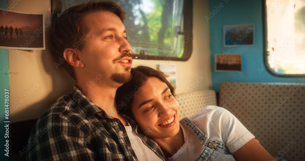 Close Up Portrait of a Young Loving Couple Enjoying Time Together, Cuddling and Chatting in a Cozy Motorhome. Adventurous Man and Female Travelling, Camping in a Caravan and Enjoying Nomad Lifestyle Close Up Portrait of a Young Loving Couple Enjoying Time Together, Cuddling and Chatting in a Cozy Motorhome. Adventurous Man and Female Travelling, Camping in a Caravan and Enjoying Nomad Lifestyle