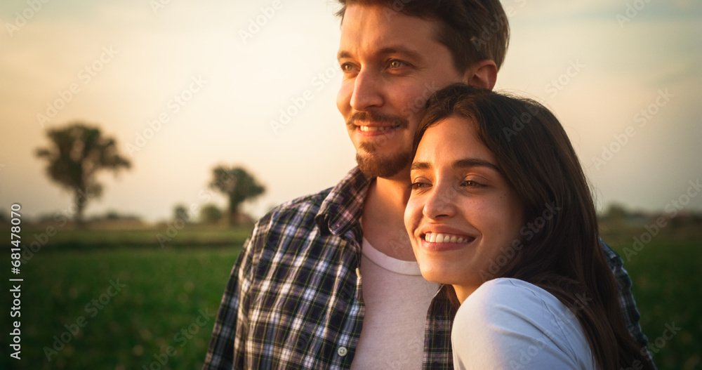 Close Up Portrait of a Beautiful Young Couple Standing Outdoors and Looking at the Beauty of Nature. Dear Life-Long Friends Enjoy Being in a Relationship. Rural Sunset Landscape in the Background Close Up Portrait of a Beautiful Young Couple Standing Outdoors and Looking at the Beauty of Nature. Dear Life-Long Friends Enjoy Being in a Relationship. Rural Sunset Landscape in the Background