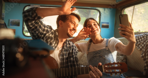 Happy Smiling Couple Taking a Selfie Photo for Family, Relatives or Friends. Having Funny Conversations on Video Call. Young Man and Woman Travelling in a Motorhome, Recording Video for Social Media