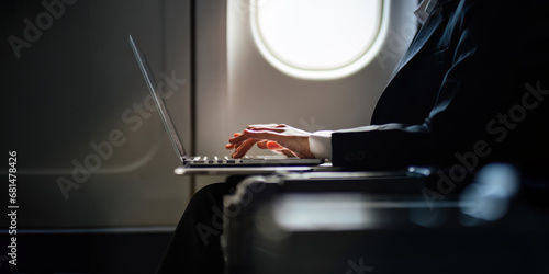 Cuadro en lienzo Successful Asian business woman, Business woman working in airplane cabin during