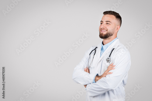Smiling european male doctor with arms crossed. © Prostock-studio