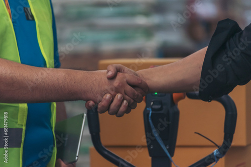 Close up warehouse worker shakehand together. Engineer man hands partnership. Diversity Coworker Men logistics Warehouse teams handshake. Multiracial Support team greeting person teamwork colleagues