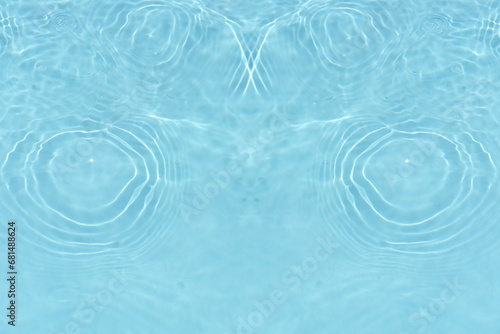 Blue water with ripples on the surface. Defocus blurred transparent white-black colored clear calm water surface texture with splash and bubbles. Water waves with shining pattern texture background.