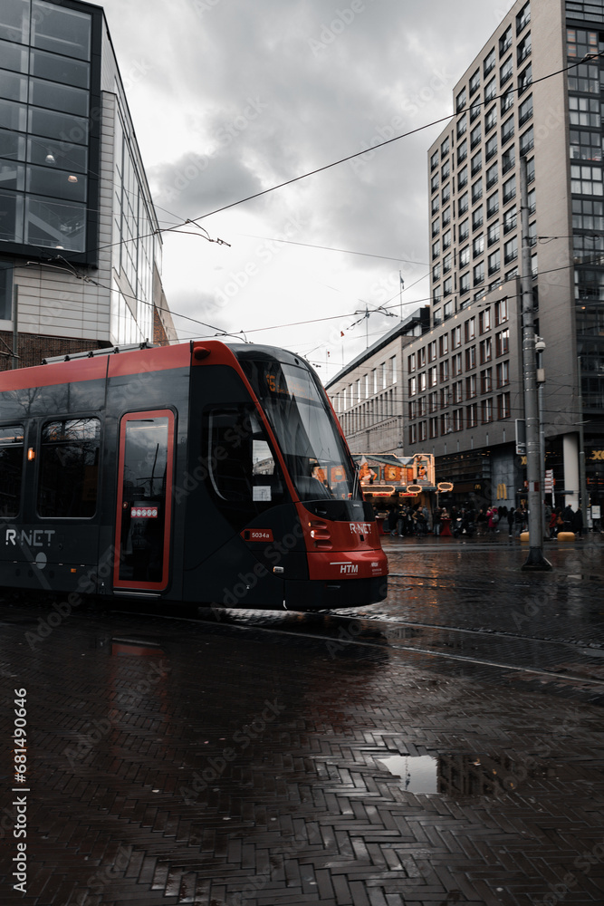 Moody weather with a red tram passing and buildings in the background_3