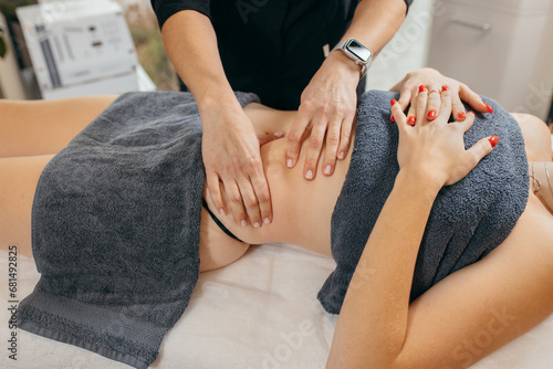 Female hands doing abdominal massage