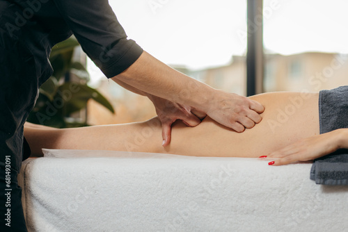 Female hands doing leg massage photo