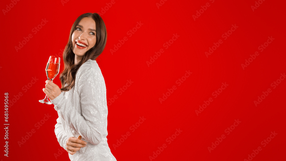 woman in festive attire holding glass of wine, red background woman in festive attire holding glass of wine, red background