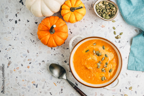 Roasted pumpkin and carrot soup with cream and pumpkin seeds
