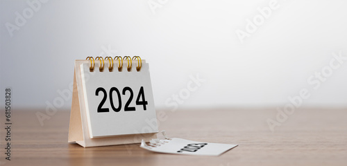 2024 Happy New year background. Turns over a calendar sheet. Setup objective target business cost and budget planning of new year concept. year change from 2023 to 2024.