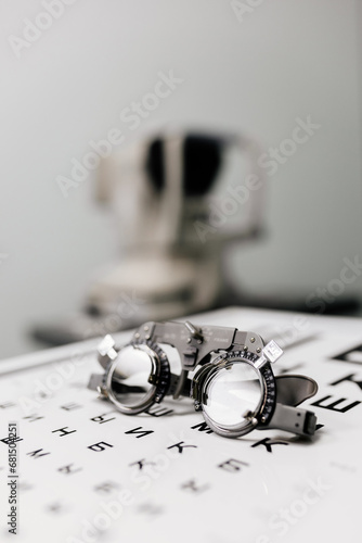 Image of test glasses with letter diagram for eye examination, vision optometry background. Vision diagnostics and prevention concept.