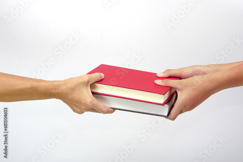 Two people exchanging books or sharing books on white background. exchanging knowledge and education concept.
