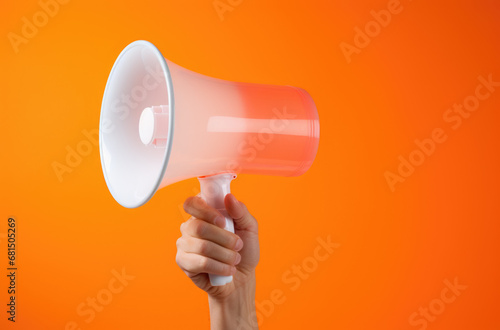 hand holding orange megaphone.