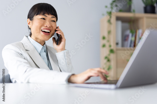 Japanese business woman using smart phone in office