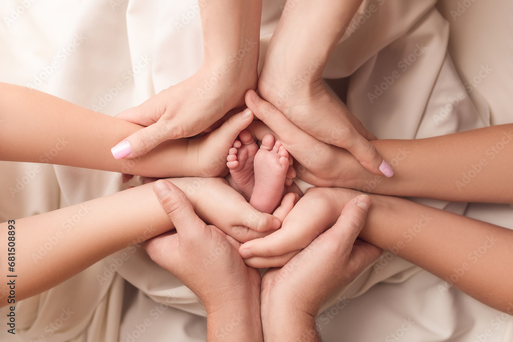 Children's legs in the hands of parents. Children's legs on a white background. Children's legs in the hands of parents. Children's legs on a white background.