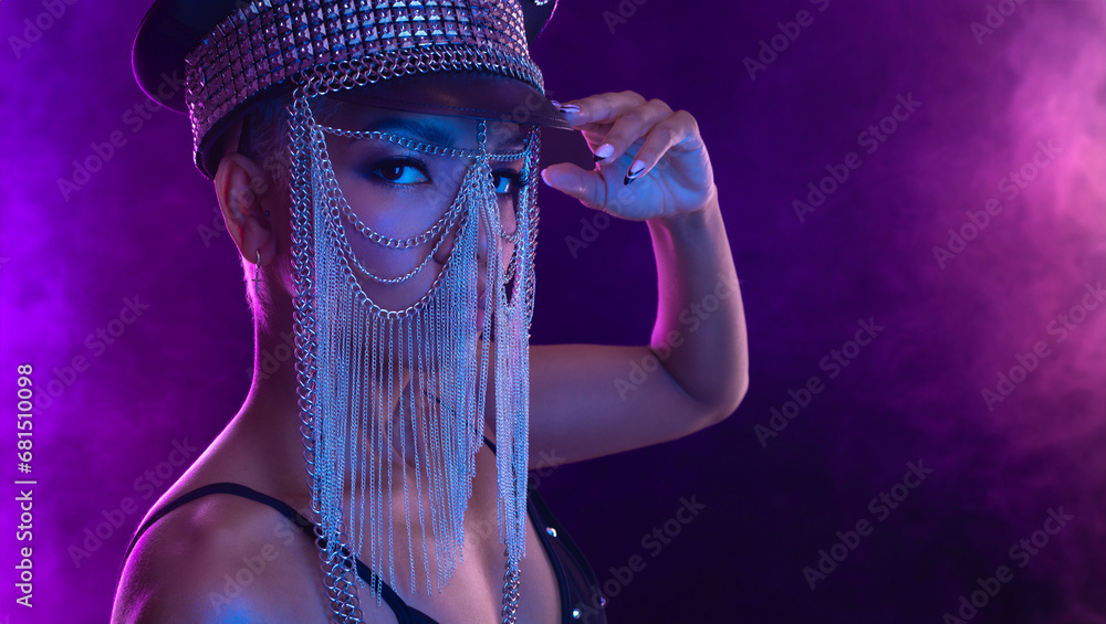 Hipster fashion girl, african american model wear headphones enjoy listen new cool music mix. Woman stand at purple studio background in trendy club purple party light with fog.