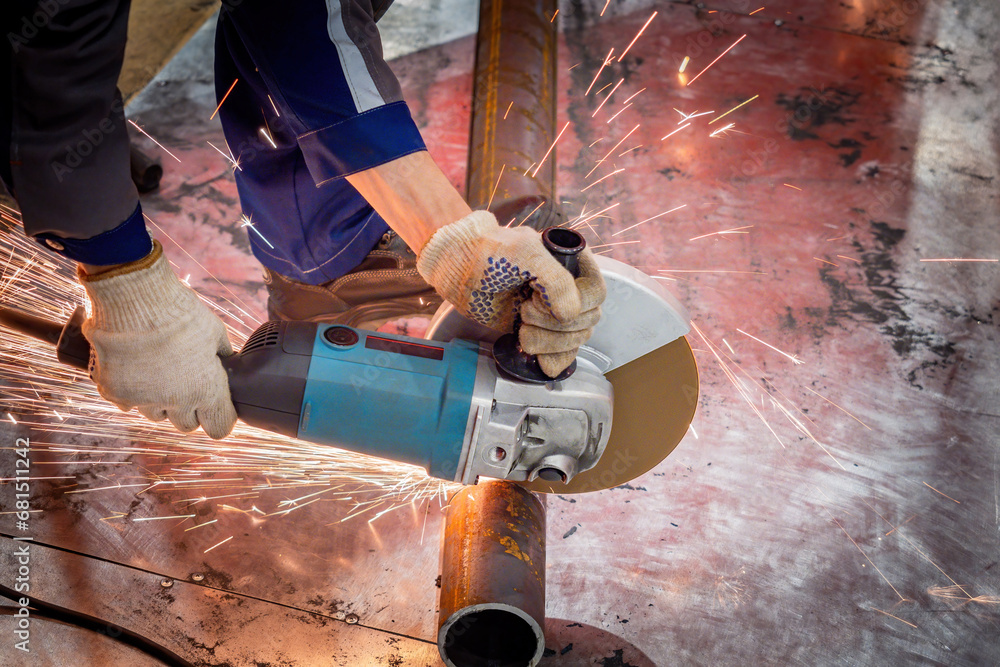 Handheld circular saw for cutting pipes. Sawing metal pipeline. Hands