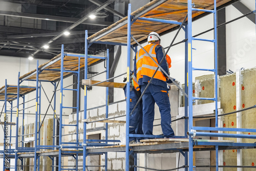 Workers men stand on constr...