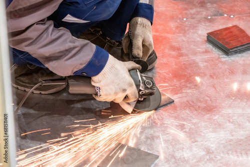 Grinding metal plates. Mast...