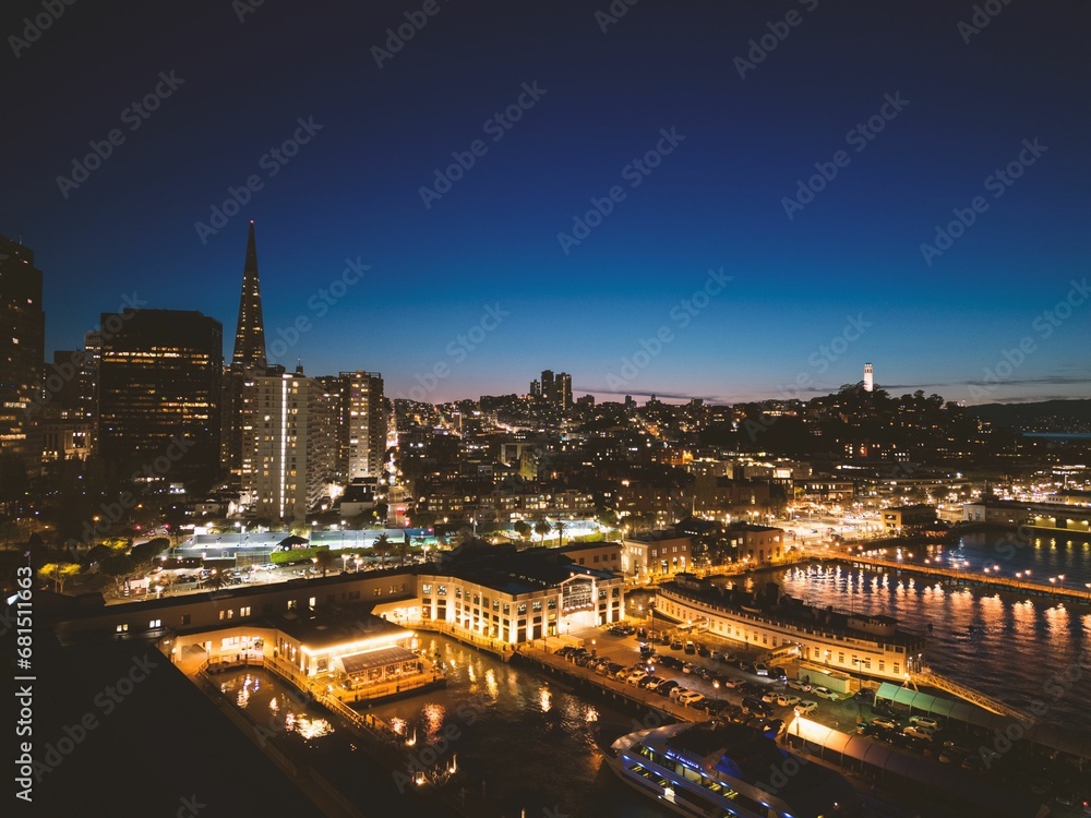 the san skyline and harbor at night, taken from a rooftop