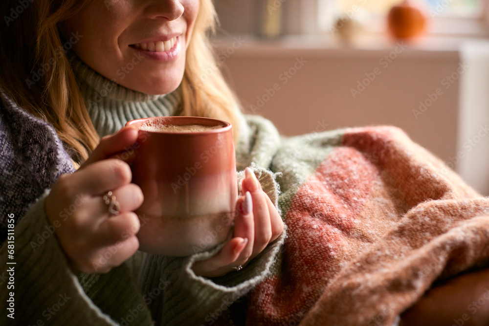 Close Up Of Woman At Home Wearing Winter Jumper With Warming Hot Drink Of Coffee In Cup Or Mug Close Up Of Woman At Home Wearing Winter Jumper With Warming Hot Drink Of Coffee In Cup Or Mug