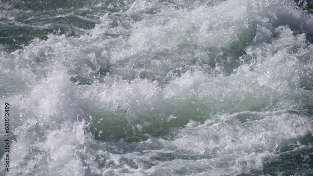 slow-motion shooting of a rapid mountain river of turquoise color, splashes. close-up slow-motion shooting of a rapid mountain river of turquoise color, splashes. close-up