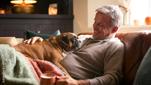 Photography Mature Man At Home In Jumper With Hot Drink Of Tea Or Coffee In Cup Stroking Pet