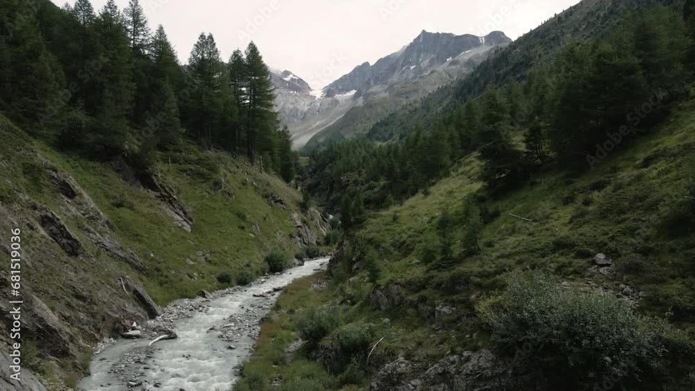 Drone flying on a white alpine river surrounded by pine trees - Val Nera Livigno Drone flying on a white alpine river surrounded by pine trees - Val Nera Livigno