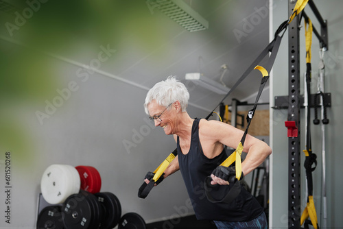 Woman using training equipment in gym
