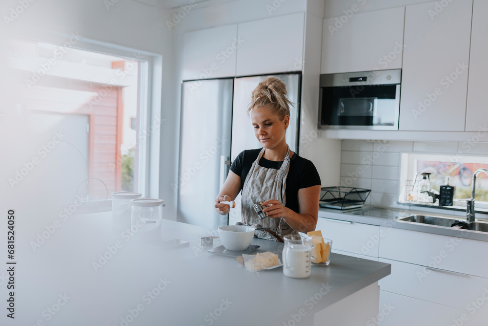 Young woman baking in kitchen Young woman baking in kitchen