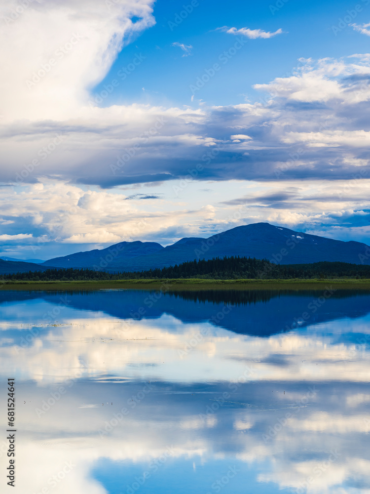View of cloudy sky reflecting in lake