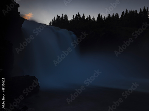 Low angle view of waterfall at dusk photo