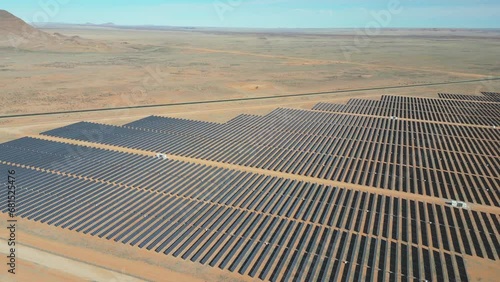 Slow drift over grid of solar panels on PV electrical power station photo