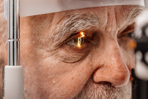 Close-up of an eye on an ophthalmology examination of an elderly man. The concept of advertising for vision correction and treatment. photo