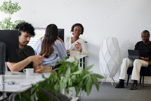 People sitting and using computers in office photo