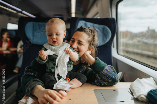 Woman traveling with baby by train photo