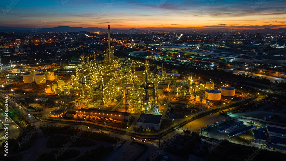 Fototapeta premium Aerial view of the morning of the oil refinery from the drone of the tower of the Petrochemistry industry in the oil​ and​ gas​ ​industry with​ cloud​ sun orange​