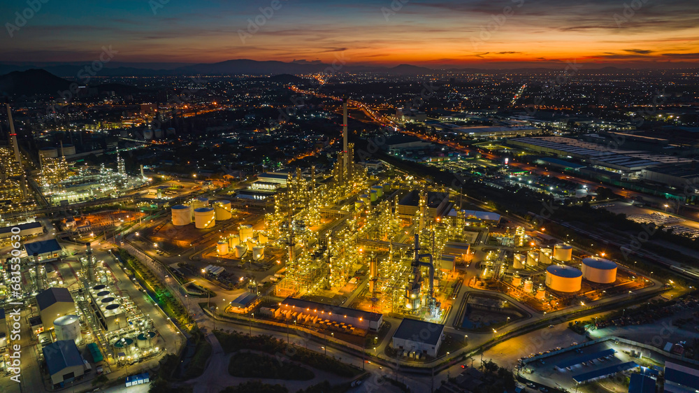 Aerial view of the morning of the oil refinery from the drone of the tower of the Petrochemistry industry in the oil​ and​ gas​ ​industry with​ cloud​ sun orange​