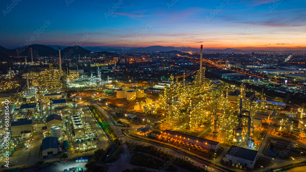 Obraz premium Aerial view of the morning of the oil refinery from the drone of the tower of the Petrochemistry industry in the oil​ and​ gas​ ​industry with​ cloud​ sun orange​