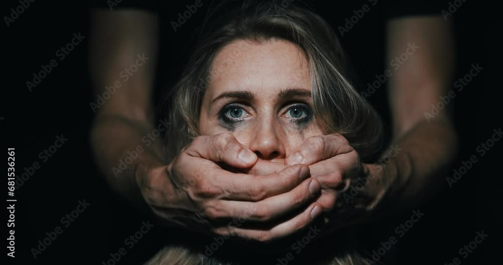 abuse and domestic violence. violent relationship. aggressive man covering helpless woman's mouth abuse and domestic violence. violent relationship. aggressive man covering helpless woman's mouth