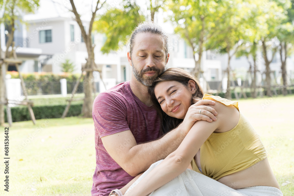 Happy smiling couple hugging outdoors in the park Happy smiling couple hugging outdoors in the park