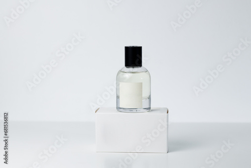 Perfume in a folded bottle with a box on a white background