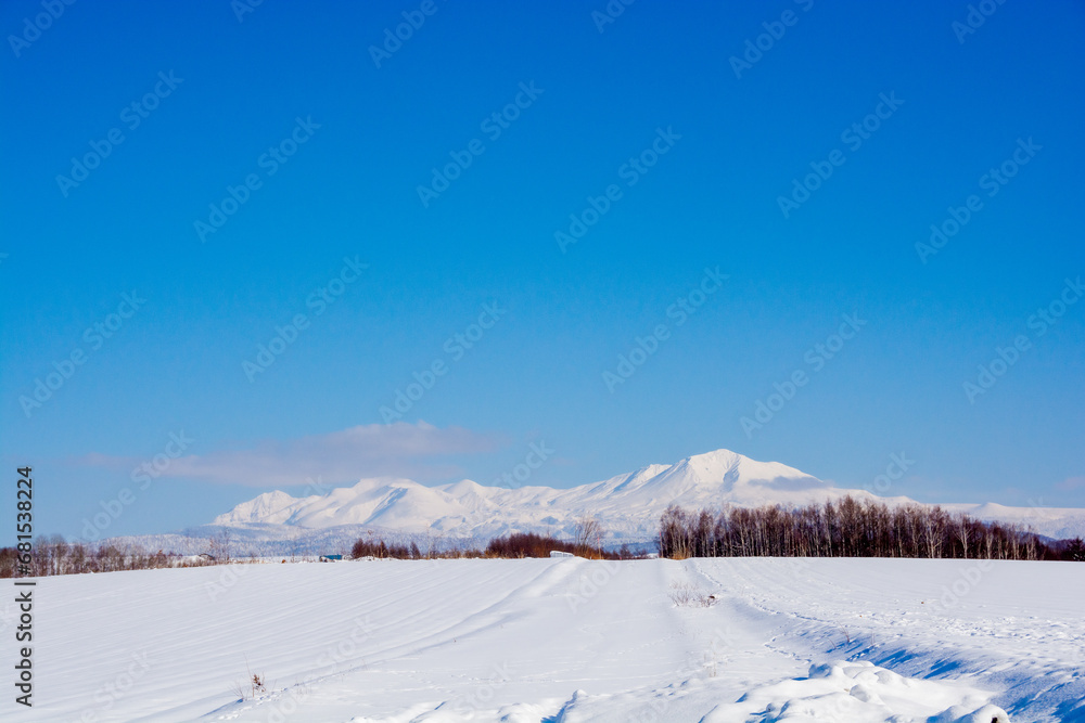 晴れた日の冬の丘陵地帯と雪山　大雪山

