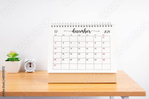 December Monthly desk calendar for 2023 year and alarm clock.