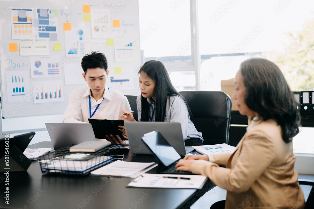 Business team discuss at meeting room. working together with laptop ,tablet and smart phone on desk Financial accountant at office Business team discuss at meeting room. working together with laptop ,tablet and smart phone on desk Financial accountant at office